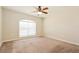Spacious bedroom with ceiling fan and neutral carpeting at 31817 Sunpark Cir, Leesburg, FL 34748