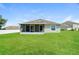 Spacious backyard with a screened patio and well-maintained lawn at 31817 Sunpark Cir, Leesburg, FL 34748