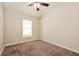 Bright bedroom with window, ceiling fan and neutral decor at 31817 Sunpark Cir, Leesburg, FL 34748