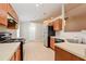 Kitchen with stainless steel appliances and wood cabinets at 31817 Sunpark Cir, Leesburg, FL 34748