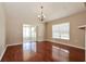 Dining room with hardwood floors and access to a screened porch at 31817 Sunpark Cir, Leesburg, FL 34748