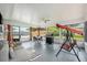 Relaxing screened porch with seating, grill, and backyard access at 1075 8Th Nw St, Winter Haven, FL 33881