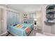 Light and airy bedroom with a teal colored bedspread at 1075 8Th Nw St, Winter Haven, FL 33881
