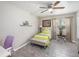 Bright bedroom with tile floors, a ceiling fan, and a view of the backyard at 1075 8Th Nw St, Winter Haven, FL 33881