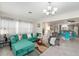 Bright living room with teal sectional sofa and stylish decor at 1075 8Th Nw St, Winter Haven, FL 33881
