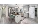 Modern kitchen featuring gray cabinets, granite counters, and island at 1075 8Th Nw St, Winter Haven, FL 33881