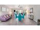Dining area with teal chairs and view into kitchen at 1075 8Th Nw St, Winter Haven, FL 33881