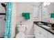 Clean bathroom with teal shower curtain and granite vanity at 1075 8Th Nw St, Winter Haven, FL 33881
