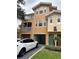 Two-story condo building with attached garage and landscaped grounds at 12031 Villanova Dr # 110, Orlando, FL 32837