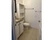 Bathroom with granite countertop, white cabinets and tiled floors at 12031 Villanova Dr # 110, Orlando, FL 32837