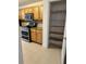 Kitchen with wood cabinets and pantry at 12031 Villanova Dr # 110, Orlando, FL 32837