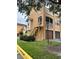 Side view of the condo building with a private staircase and garage at 12031 Villanova Dr # 110, Orlando, FL 32837