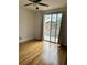 Spacious bedroom featuring hardwood floors and a balcony view at 12031 Villanova Dr # 110, Orlando, FL 32837
