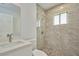 Modern bathroom with walk-in shower and pebble floor at 2851 Palm Ave, Indian Lake Estates, FL 33855