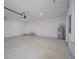 Bright and clean garage featuring an overhead door and utility hookups at 2851 Palm Ave, Indian Lake Estates, FL 33855