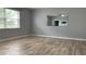 Spacious bedroom with wood-look tile floors and large windows at 2301 Golden Aster St, Clermont, FL 34711