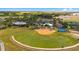Aerial view of community with sports facilities, including baseball field and basketball court at 7067 Sw 91St Ct, Ocala, FL 34481