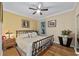 Guest bedroom with king-size bed, ceiling fan and hardwood floors at 7067 Sw 91St Ct, Ocala, FL 34481