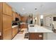 Eat-in kitchen with an island, stainless steel appliances and wood cabinets at 7067 Sw 91St Ct, Ocala, FL 34481