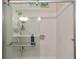 Walk-in shower with glass enclosure and built-in shelving at 7067 Sw 91St Ct, Ocala, FL 34481