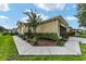 Tan house with walkway, landscaping, and outdoor lighting at 7067 Sw 91St Ct, Ocala, FL 34481