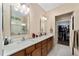 Double vanity bathroom with granite countertop and walk-in shower at 7067 Sw 91St Ct, Ocala, FL 34481