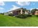 Landscaped backyard with a screened patio at 7067 Sw 91St Ct, Ocala, FL 34481