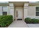 House entrance with white door and lush shrubs at 7067 Sw 91St Ct, Ocala, FL 34481