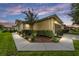Tan house with walkway, landscaping, and outdoor lighting at 7067 Sw 91St Ct, Ocala, FL 34481