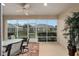 Relaxing screened porch with patio furniture and view of backyard at 7067 Sw 91St Ct, Ocala, FL 34481