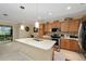 Modern kitchen with island, stainless steel appliances, and wood cabinets at 7067 Sw 91St Ct, Ocala, FL 34481