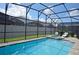 Enclosed pool and spa with patio furniture at 9014 Pelican Cove Trl, Kissimmee, FL 34747