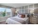 Main bedroom with gray upholstered headboard and large windows at 1968 Rosewood Cir, Lakeland, FL 33810