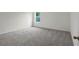 Spacious bedroom with gray carpet and large window at 14945 Sw 38Th Cir, Ocala, FL 34473