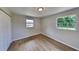 Simple bedroom with neutral walls and wood-look tile floors at 1737 Jacobs Rd, South Daytona, FL 32119