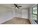 Well-lit bedroom, featuring wood-look floors and ceiling fan at 1737 Jacobs Rd, South Daytona, FL 32119