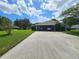 Two-car carport with driveway and surrounding landscape at 1140 E George St, Bartow, FL 33830