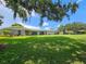 House exterior showcasing a wide lawn and tree coverage at 1140 E George St, Bartow, FL 33830