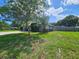 Side view of the house with a large yard and fenced area at 1140 E George St, Bartow, FL 33830