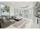Bright living room features a large sectional sofa and stunning water views at 9202 Bay Point Dr, Orlando, FL 32819