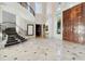 Impressive entryway with a curved staircase and marble floors at 9202 Bay Point Dr, Orlando, FL 32819