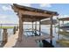 Covered boat lift on private dock with lake view at 9202 Bay Point Dr, Orlando, FL 32819