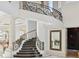 Ornate staircase with wrought iron railings and marble flooring at 9202 Bay Point Dr, Orlando, FL 32819