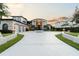 Stunning waterfront home with circular driveway and landscaping at 9202 Bay Point Dr, Orlando, FL 32819