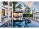 Relaxing pool and patio area with serene waterfront views at sunset at 9202 Bay Point Dr, Orlando, FL 32819