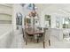 Bright dining area with a gorgeous wood table and large windows at 9202 Bay Point Dr, Orlando, FL 32819