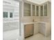 Butlers pantry with glass cabinets and wine coolers at 9202 Bay Point Dr, Orlando, FL 32819