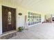 Welcoming front porch with tile flooring and planters at 1140 E George St, Bartow, FL 33830