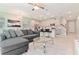 Open floor plan with L-shaped sofa and kitchen island at 2174 Fleming Mist Pl, Kissimmee, FL 34747