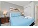 Serene bedroom with light blue bedding and double door closet at 2174 Fleming Mist Pl, Kissimmee, FL 34747